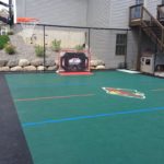 Multi-sport outdoor game court with SnapSports athletic tiles and customized with a Minnesota Wild grapic