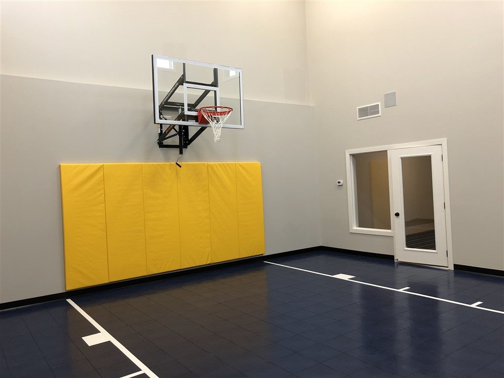 Twin Cities Spring Parade of Homes indoor basketball court featuring SnapSports athletic floor tiles installed by Millz House