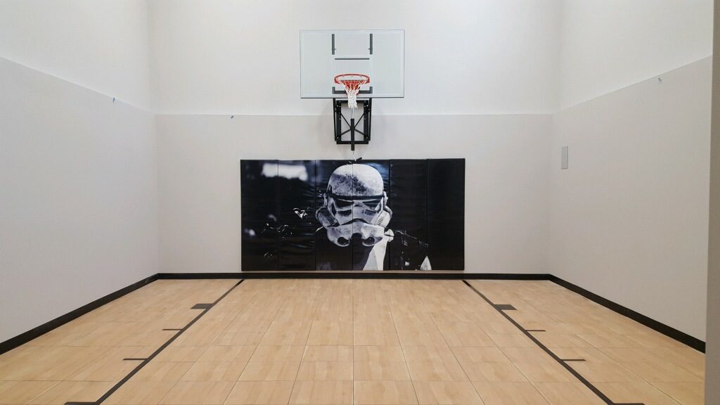 Millz House / SnapSports MN installed indoor basketball court featuring Star Walls Wall Pad