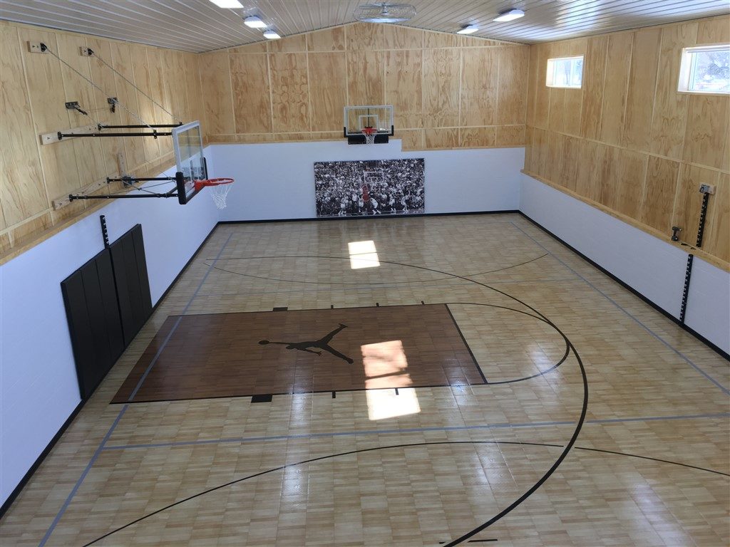 Indoor basketball and volleyball court installed by Millz House featuring SnapSports athletic flooring
